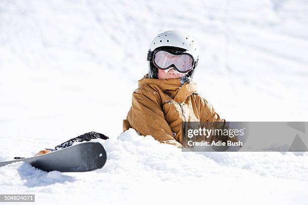 young boy covered in snow with skis - winter sport stock pictures, royalty-free photos & images