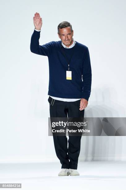 Designer Dries Van Noten acknowledges the audience at the end of his show as part of the Paris Fashion Week Womenswear Spring/Summer 2018 on...