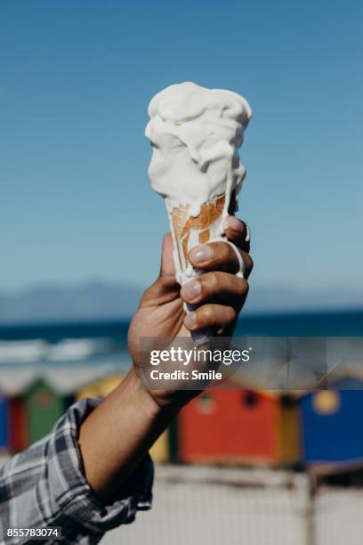 ice-cream melting on a hand - gelato foto e immagini stock
