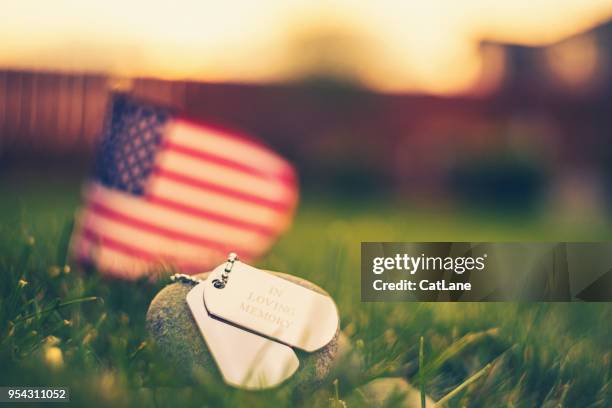 memorial day flag and dog tags in evening sunshine - workers memorial day stock pictures, royalty-free photos & images