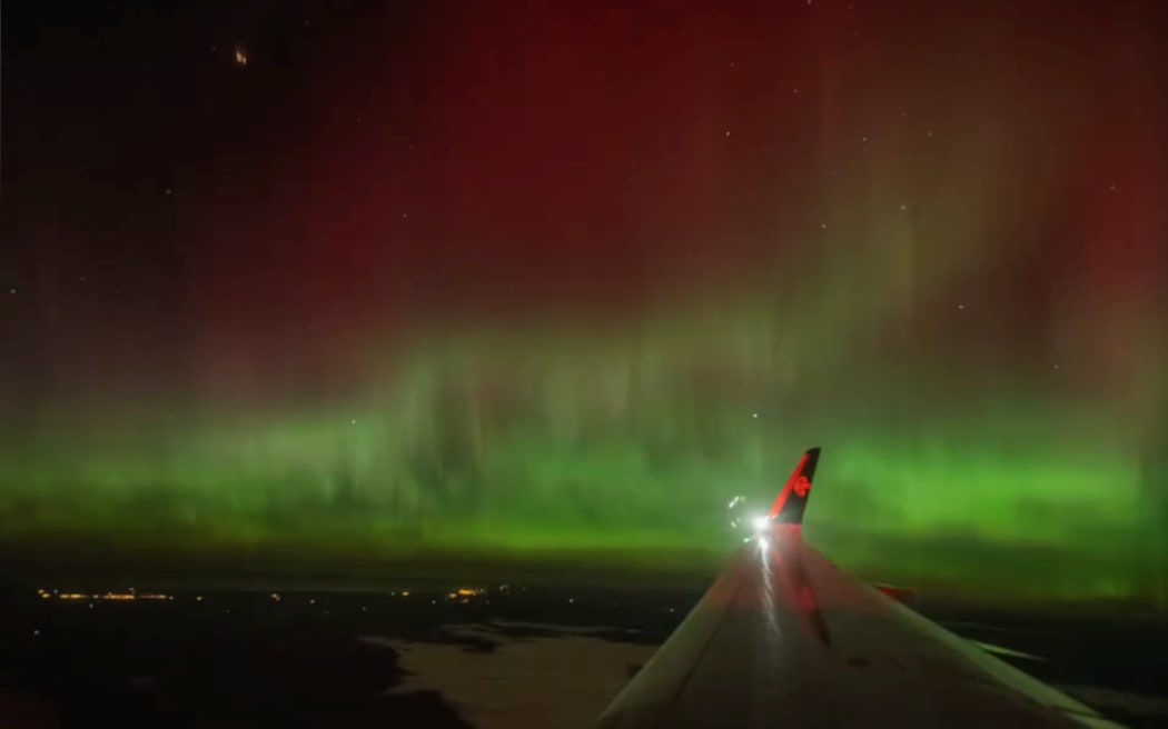 A traveller's view of the aurora from their flight landing into Christchurch at midnight on 12 May, 2024.