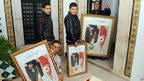 Tunisian government employees remove portraits of former President Ben Ali