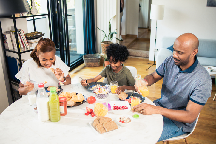 Happy family spends quality time together during breakfast