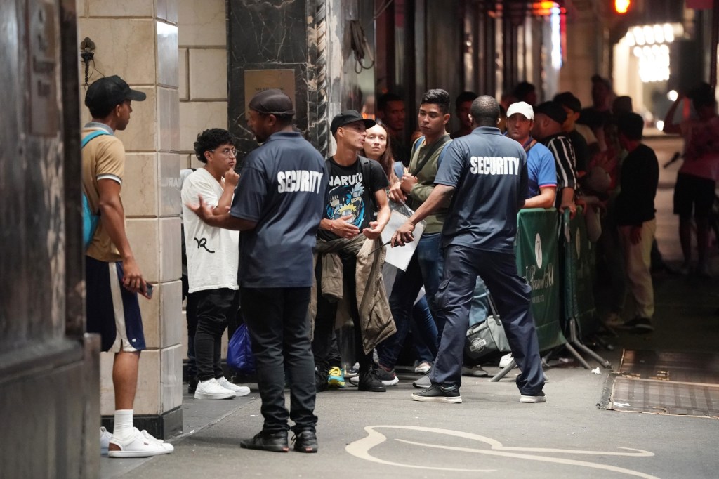 Apparent migrants and security personnel seen outside of the Roosevelt Hotel in New York, NY on July 21, 2023.