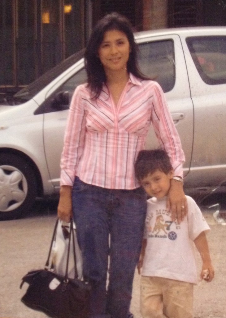 isabelle volpe in a pink shirt blue jeans holding a bag while her other arm is wrapped around young anthony