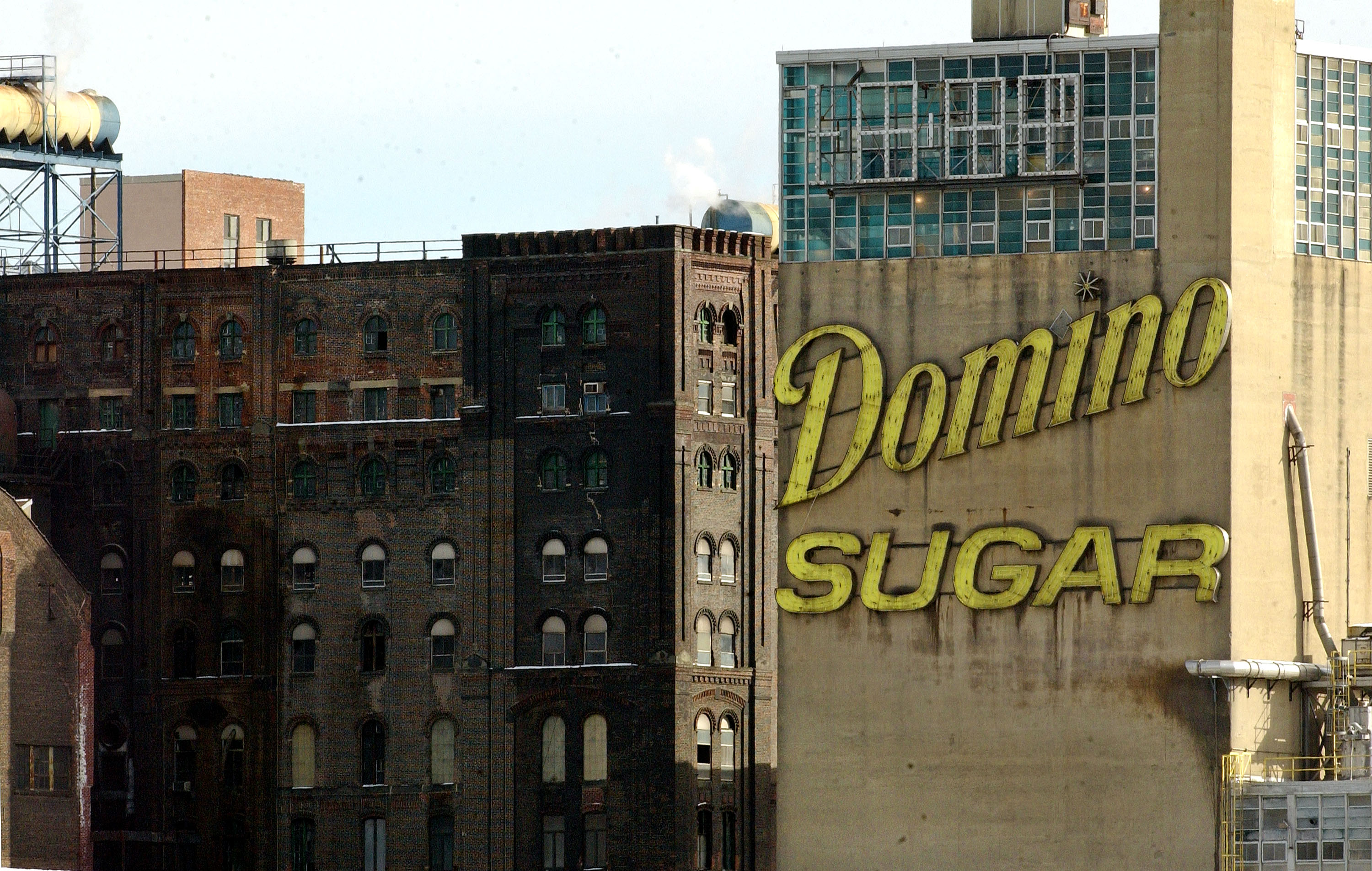 Yellow sign reading 'Domino Sugar' placed on large industrial building