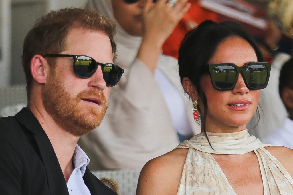 Prince Harry and Meghan Markle wear sunglasses during their trip to Nigeria.