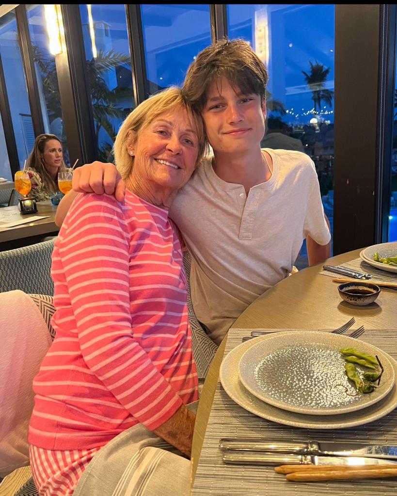 Tom Brady's mom sitting with his son
