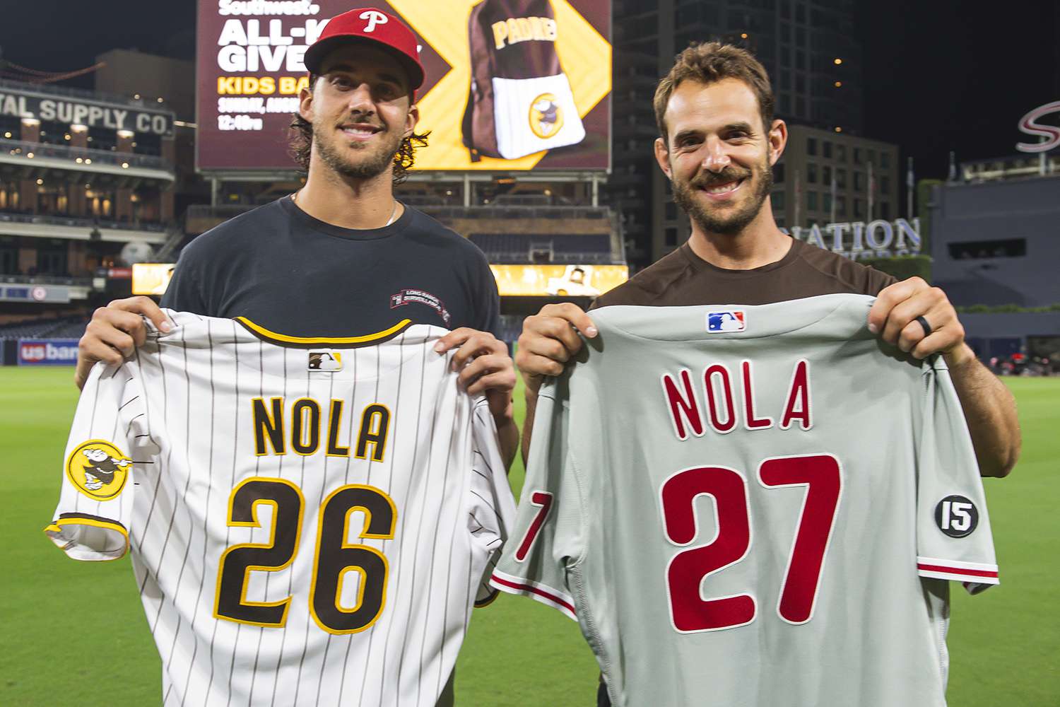 SAN DIEGO, CA - AUGUST 21: Austin Nola #26 of the San Diego Padres swaps jerseys with his brother Aaron Nola #27 of the Philadelphia Phillies on August 21, 2021 at Petco Park in San Diego, California. (Photo by Matt Thomas/San Diego Padres/Getty Images)