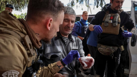 Military paramedics treat a wounded local resident during an evacuation to Kharkiv due to Russian shelling, amid Russia's attack on Ukraine, in Kharkiv region, Ukraine May 12,2024.