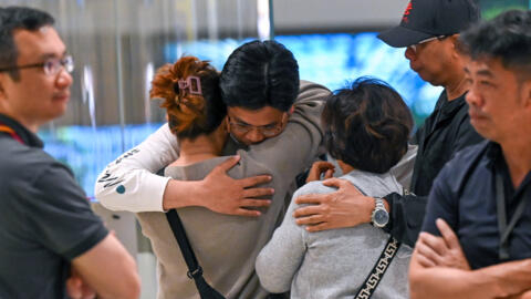 Passengers of Singapore Airlines flight SQ321 from London to Singapore, which made an emergency landing in Bangkok, greet family members upon arrival at Changi Airport in Singapore on May 22, 2024.