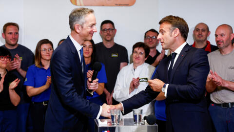 Macron shakes hands with McCain Foods CEO Max Koeune on the sidelines of a day of meetings with foreign business leaders as part of the "Choose France" event, on May 13, 2024.