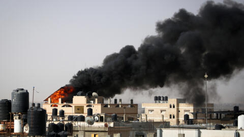 Thick, black smoke rises from a fire in a building caused by Israeli bombardment in Rafah in the southern Gaza Strip on May 10, 2024.