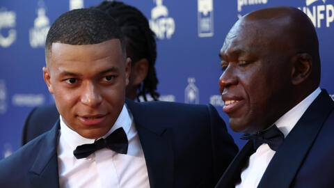 Kylian Mbappe (L) arriving with his father Wilfried at French football's annual awards ceremony in Paris on May 13,2024.