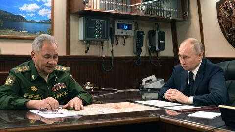 File photo of Russian President Vladimir Putin listening to Sergei Shoigu taken December 25, 2023.
