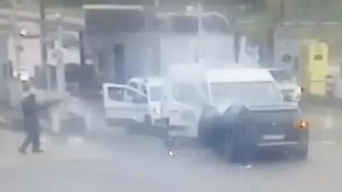 A screen grab from a CCTV video shows a person aiming as gunmen wearing balaclavas ambush a prison van to free a drug dealer in Val-de-Reuil, France May 14, 2024.