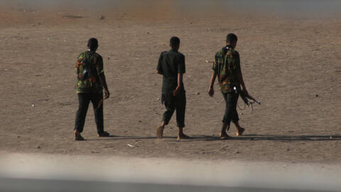 Armed men walk in Khartoum on May 22, 2023, as fighting between two rival generals persists.