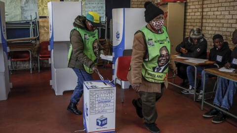 Voters wearing African National Congress (ANC) party merchandise cast their ballots at Hitekani Primary School in Soweto on 29 May, 2024.