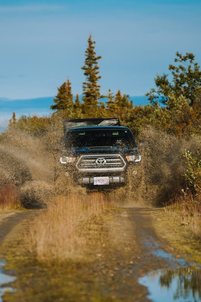 Toyota Tacoma off-road splash through water in the Yukon