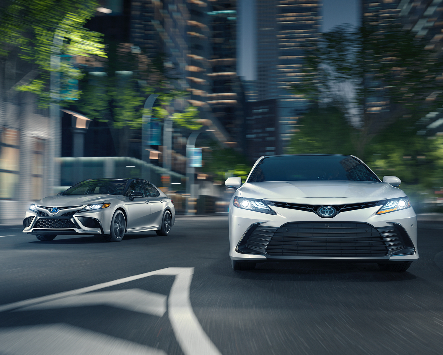Camry Hybrid XSE shown in Celestial Silver Metallic with Black Roof and Camry Hybrid XLE shown in Wind Chill Pearl