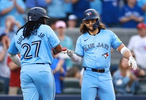 Blue Jays' Bo Bichette (right) celebrates with Vladimir Guerrero Jr. after hitting a two-run home run in the second inning against the Chicago White Sox at Rogers Centre on May 22, 2024 in Toronto.