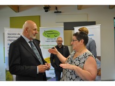 Kelly Taylor, right, founder of Urban/Rural Rides, speaks with Rejean Savoie, minister responsible for the Regional Development Corporation