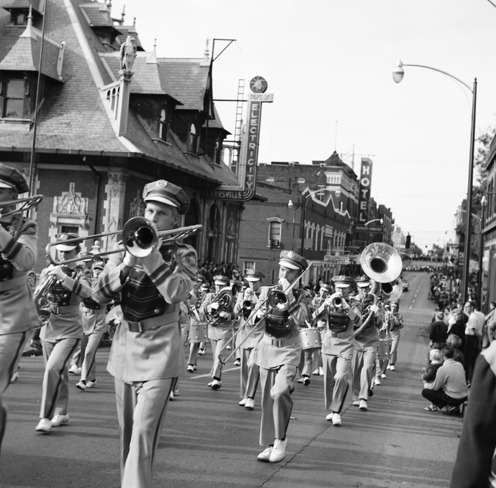 A parade marches past the building when it was home to the Clarksville Department of Electricity, 1961