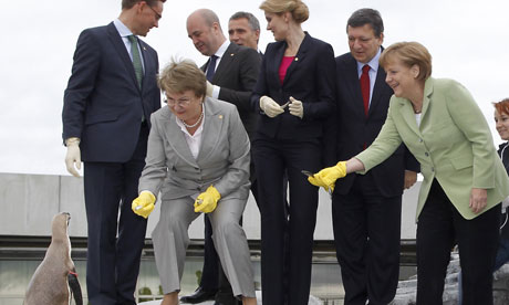 Finland's Prime Minister Jyrki Ka and Germany's Angela Merkel.