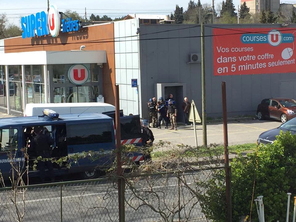 Police are seen at the scene of a hostage situation in a supermarket in Trèbes, Aude, France