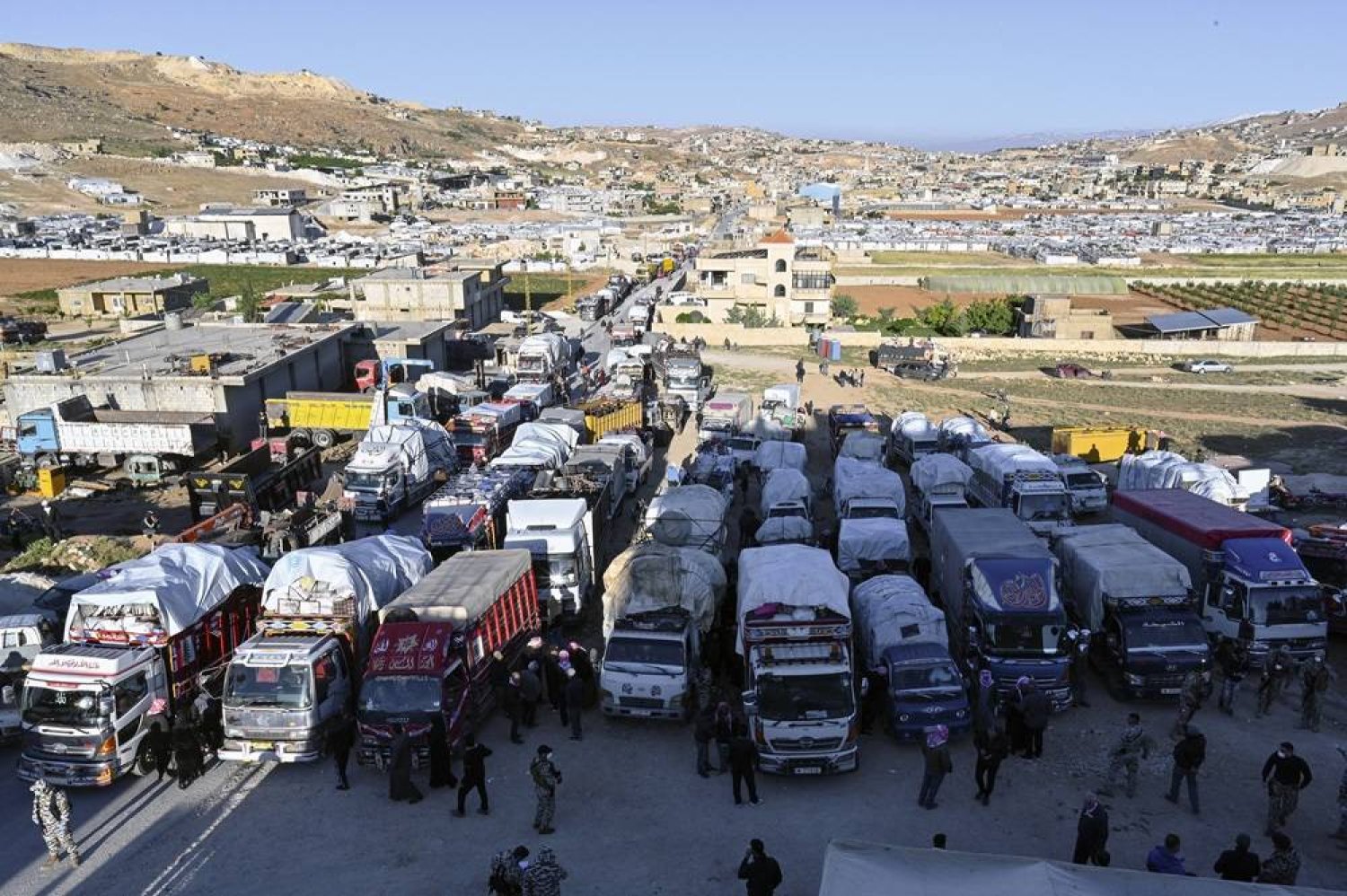 Syrian refugees gather as they prepare to leave the Arsal area, before their journey to their homes in Syria, at Arsal in Bekaa Valley, Lebanon, 14 May 2024. (EPA)