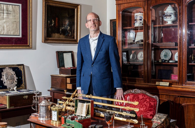 Dr. Douglas Arbittier with items from his large collection of medical antiques. When he found that many medical-themed woodblocks he bought were fake, he began an intense effort to catch the forger.